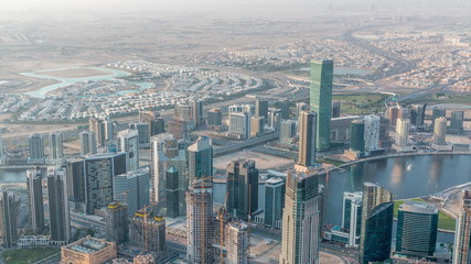 Naklejka na ściany i meble Downtown of Dubai in the morning timelapse after sunrise. Aerial view with towers and skyscrapers