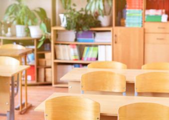School desk against the background of a classroom. Selective focus, back to school