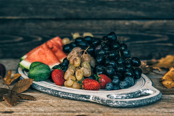 Vintage tray with autumn fruits on rustic vintage table top view. Fresh organic fruits. Food background. Healthy food. Top view. Toned image.