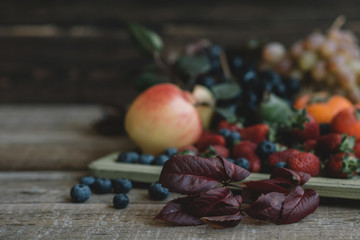 Fresh and colorful fruits in a wooden tray. Healthy fruits.