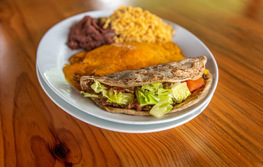 Cheese Enchilada meal with rice, beans and beef taco