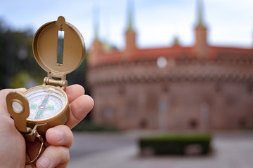 Visit to Kraków / Poland. compas showing the way to the most important monuments in the city / tourism concept © Rochu_2008