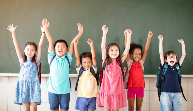 Group Of Diverse Young Students Standing Together In Classroom