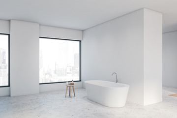 Spacious white bathroom corner with tub