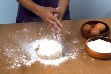 hand clipping white flour on table