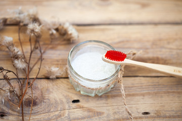 one toothbrushes, tooth powder on a wooden background, wooden brushes, bamboo brushes. Minimalism, hygiene of the mouth cavity. View from above