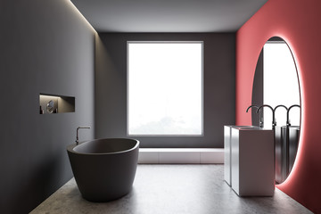 Gray and red bathroom interior with round mirror