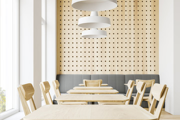 White and wooden restaurant interior with sofa
