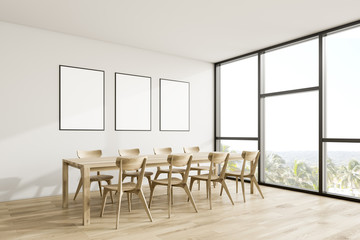 White dining room corner with poster gallery