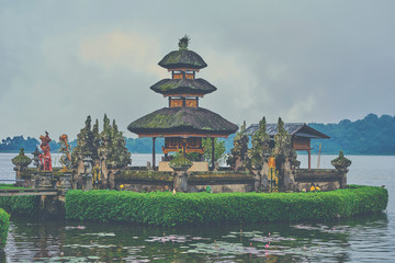 Colorful Balinese landscape with a temple. Ulun Danu Beratan Temple of Bali Island, Indonesia. Several balinese temples. Travel and ancient architecture background. Traditional balinese style.