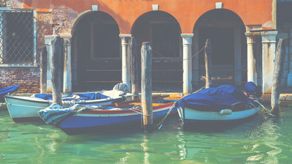 View of the canal with boats and gondolas in Venice, Italy. Venice is a popular tourist destination of Europe.