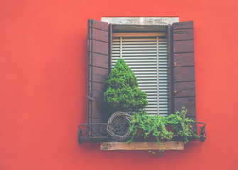 View of a beautiful house exterior and front window seen on a Venice street.