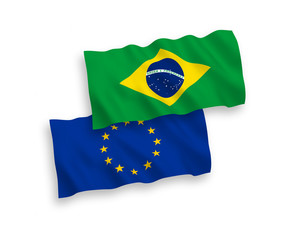 National vector fabric wave flags of European Union and Brazil isolated on white background. 1 to 2 proportion.