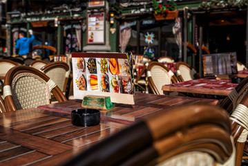 View of old street in Chamonix village, France. Cozy cityscape.Typical view of the street with tables of cafe in Chamonix.