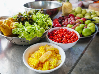 Raw materials for making vegetable salads include glass lettuce, tomatoes, corn, apples, grapes and pineapples. For health and vegetarian.