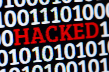 Red inscription HACKED in binary code of ones and zeros. Cyber attack electronic devices.
