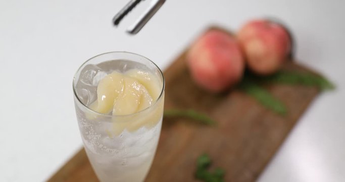 Making cold peach compote ade for summer drink