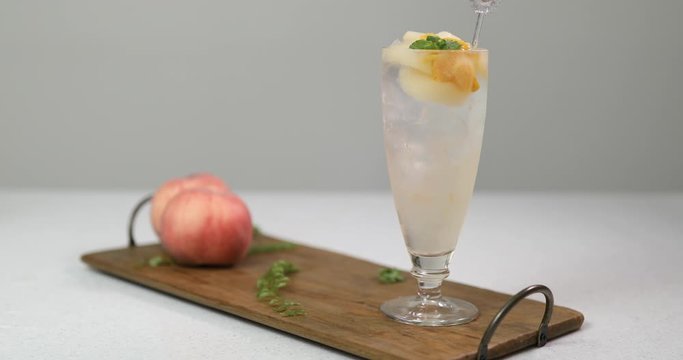 Stirring cold peach compote ade to mix together with stick