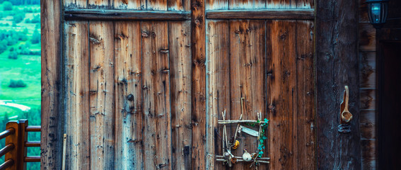 The wall of old wooden house in traditional swiss alpine village. Rural mountain chalet.
