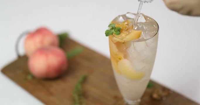 Stirring cold peach compote ade to mix together with stick