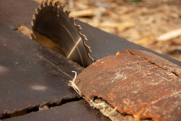 Fototapeta premium garbage at a sawmill. A circular saw is sawing a wooden piece. tree processing.
