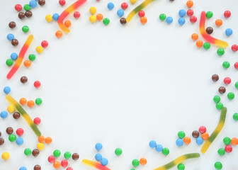 the concept of Halloween . orange pumpkin, colored sweets, candies