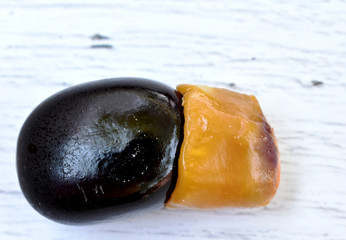Black rosewood seeds are black and yellow, beautifully decorated on a gray wood pattern table.