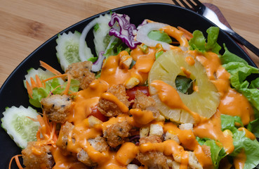 Salad and cheese dressing on table