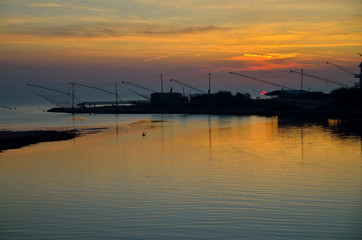 Fototapeta na wymiar sunrise on the sea with ficher nets