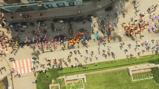 Aerial view of a ceremonial parade of young people marching along the main streets of the city along the embankment to the lake. Ternopol Ukraine. The concept of interesting youth leisure