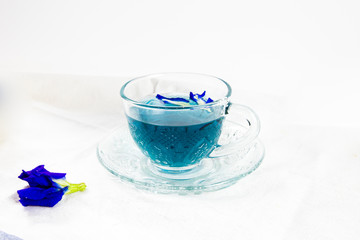 cup of pea tea and flowers on table