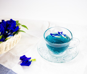 cup of pea tea and flowers on table