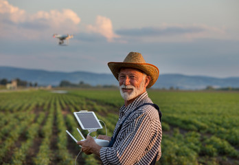 Farmer with drone in field