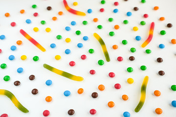 the concept of Halloween . orange pumpkin, colored sweets, candies