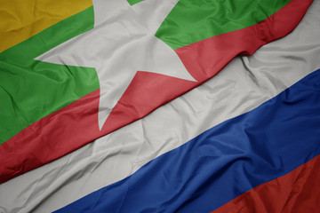 waving colorful flag of russia and national flag of myanmar.