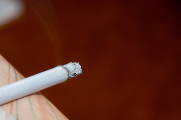 lit cigarette aimed at Copy Space
