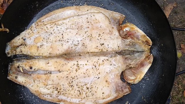 Boga fish steak cooked in a wok pan