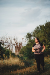 Overweight runner go jogging outdoors. Weight loss, sports, healthy lifestyle