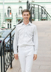 portrait of man standing in front of a building