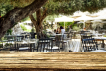 Table background with blurred outside restaurant. Empty space for advertising products and decortation.