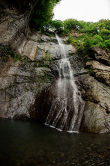 Fototapeta premium Shot of the small waterfall in the georgian mountains