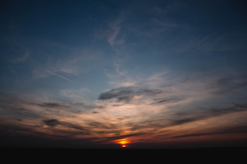 Beautiful sunset over a dark landscape. Dramatic sunset