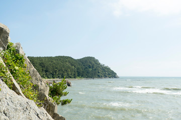 The edge of the cliff and the sea with a clear sky