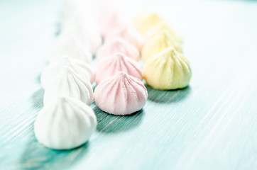 Colored sweet meringues. Dessert background.
