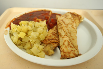 Crepes with tomato ragout as a delicious dinner in a hospital