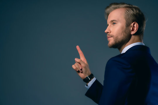 businessman hand point show one finger present invisible monitor screen isolate dark background