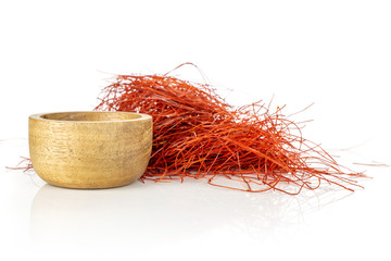 Lot of whole red chili pepper threads in wooden bowl isolated on white background