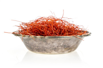 Fototapeta premium Lot of whole red chili pepper threads in old iron bowl isolated on white background