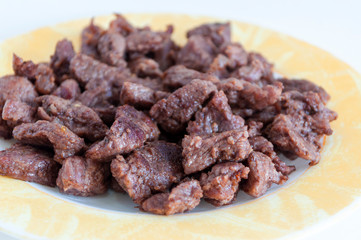 Clear shoot of tasty meat on small plate with white background