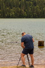 Photographer traveler taking pictures of landscape.